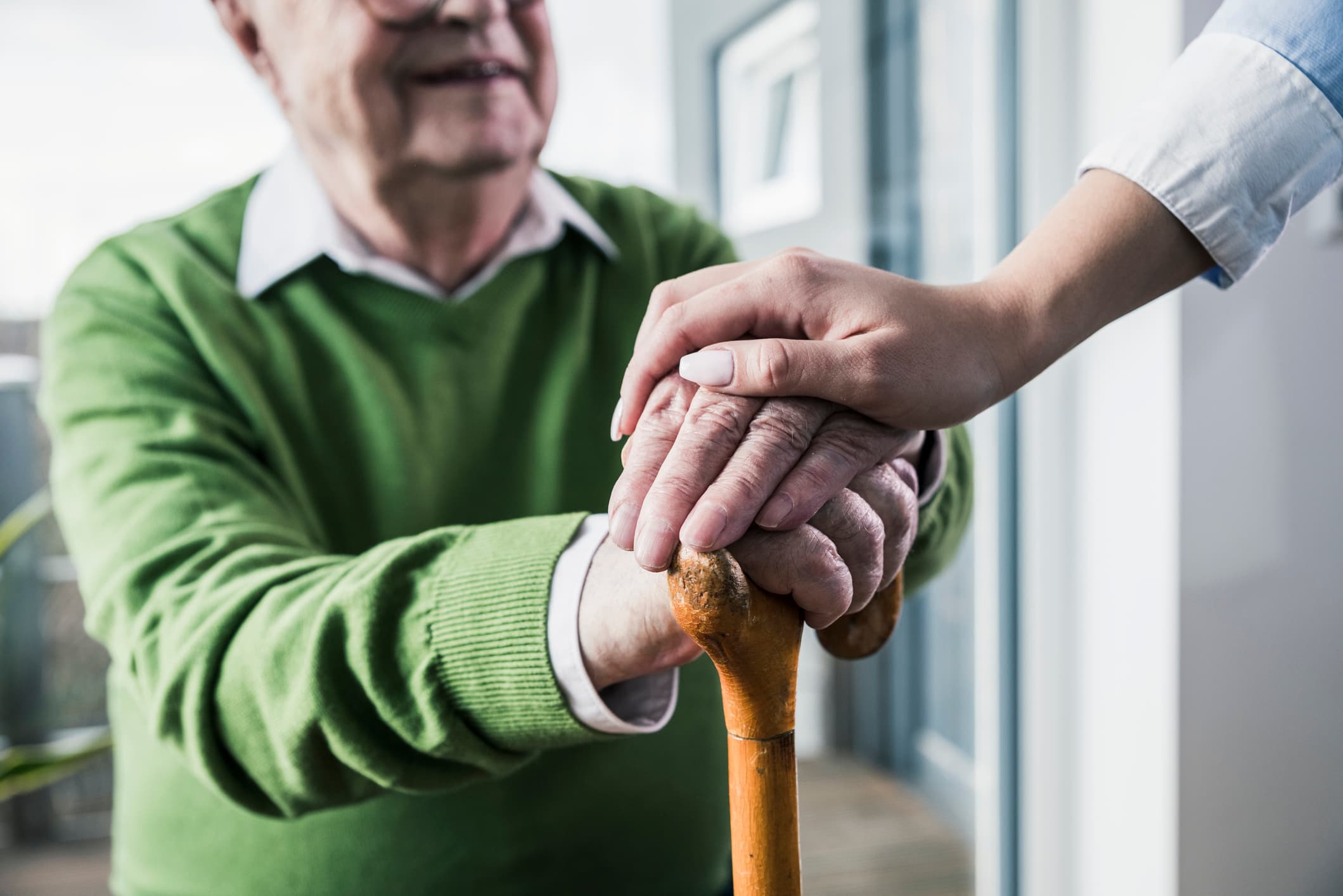 Hands on cane. Close up.