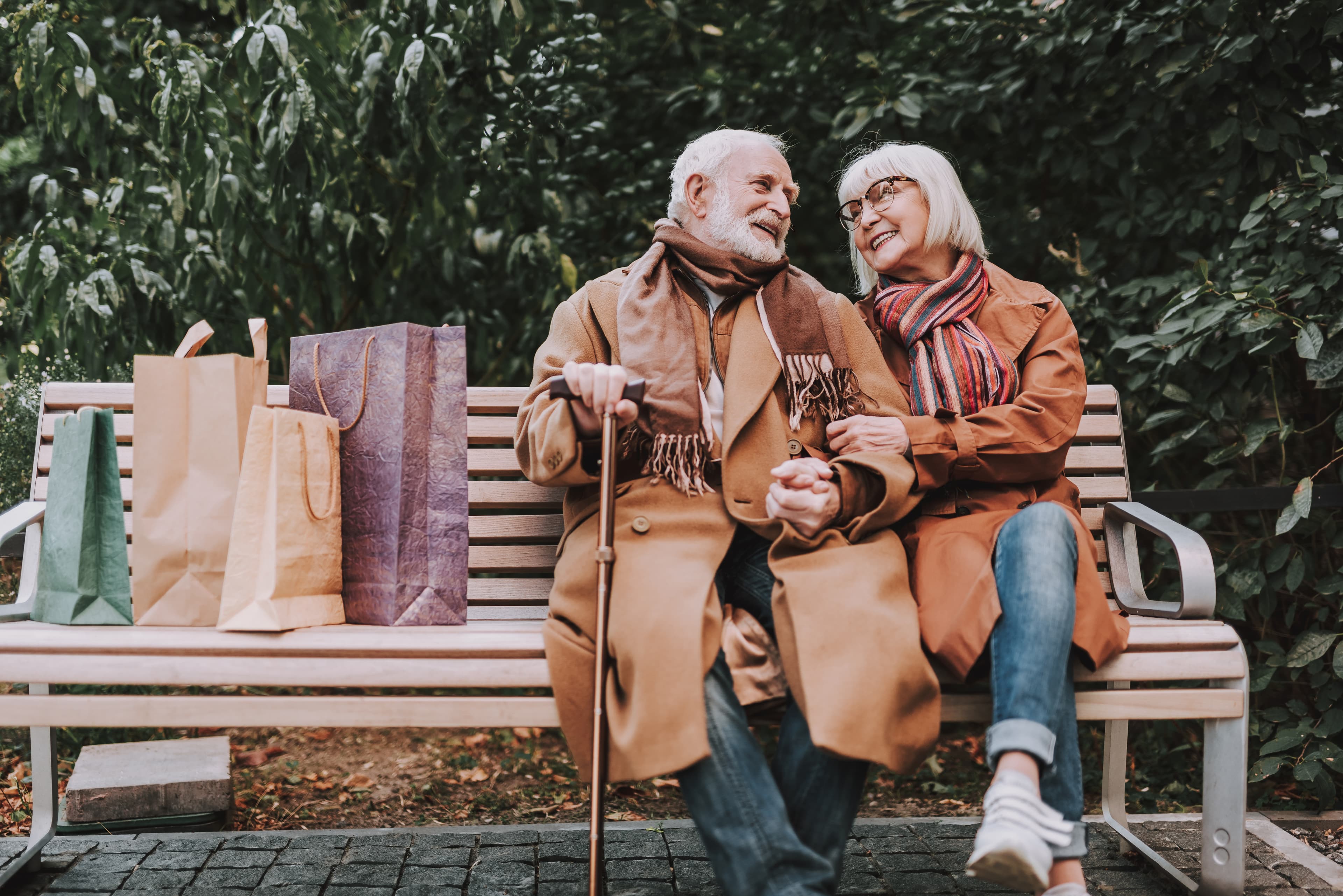 Couple. Sitting on bench.